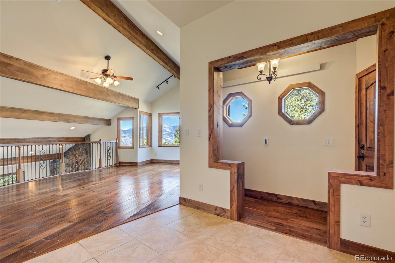 85 Santa Fe Mountain Road Evergreen, CO 80439 - Photo 2 of 47 a view of entryway with stairs and a chandelier fan