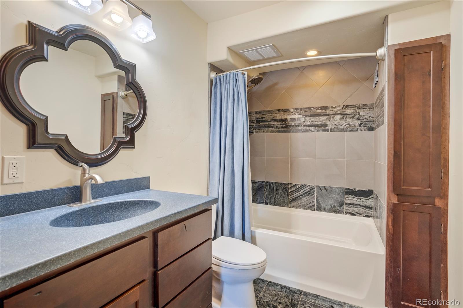 85 Santa Fe Mountain Road Evergreen, CO 80439 - Photo 24 of 47 a bathroom with a sink a toilet and a mirror