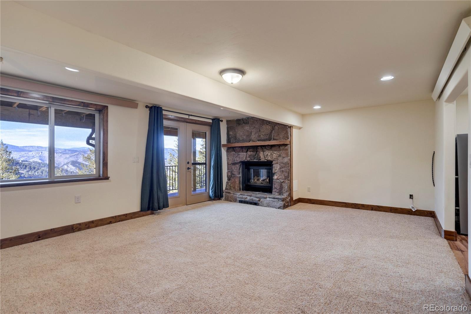 85 Santa Fe Mountain Road Evergreen, CO 80439 - Photo 29 of 47 a view of an empty room with a fireplace