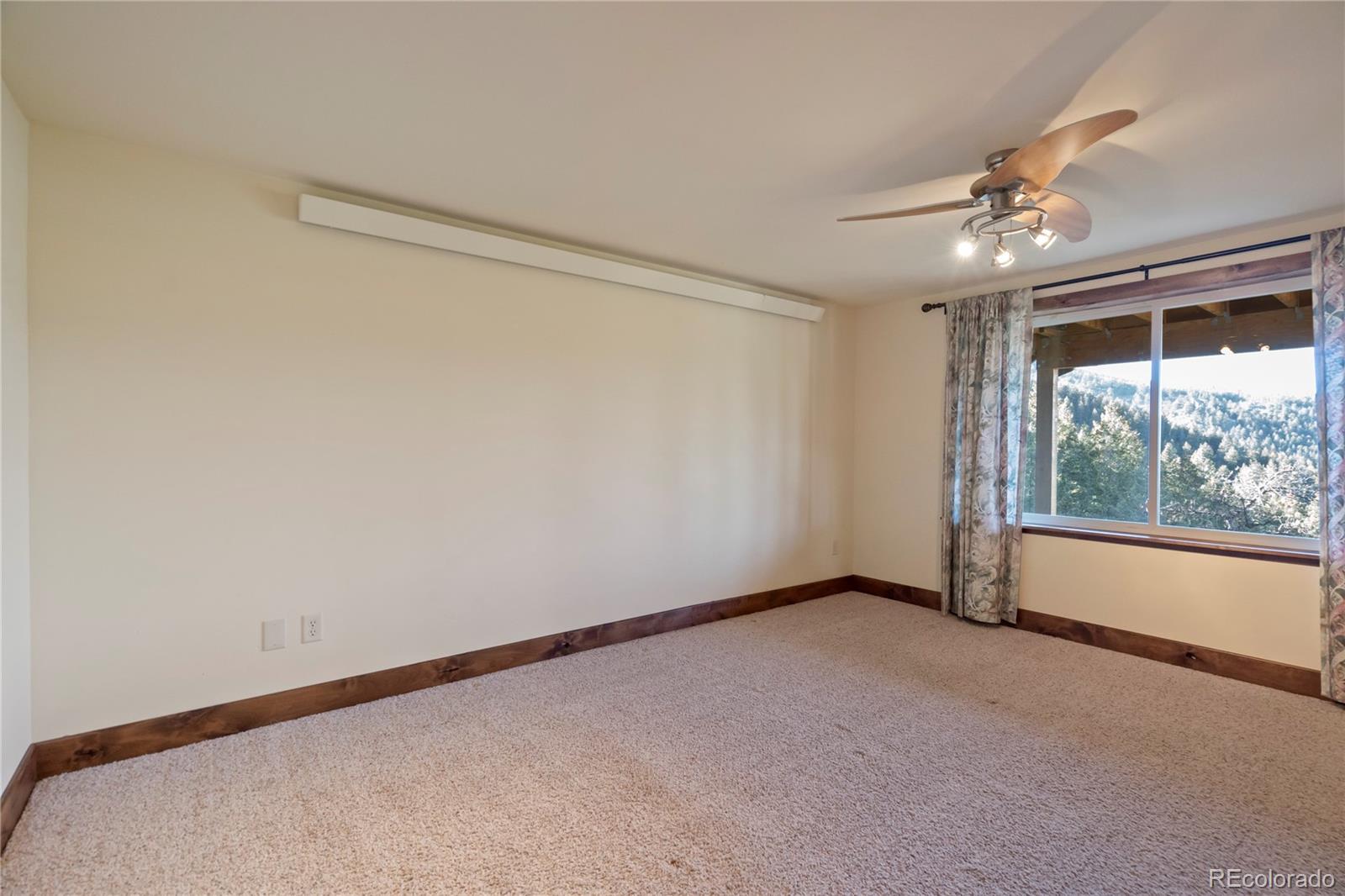 85 Santa Fe Mountain Road Evergreen, CO 80439 - Photo 32 of 47 a view of an empty room with a window