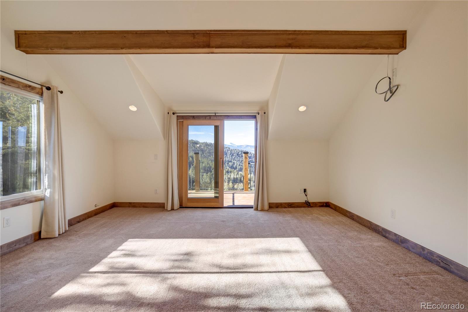 85 Santa Fe Mountain Road Evergreen, CO 80439 - Photo 4 of 47 a view of an empty room with a window