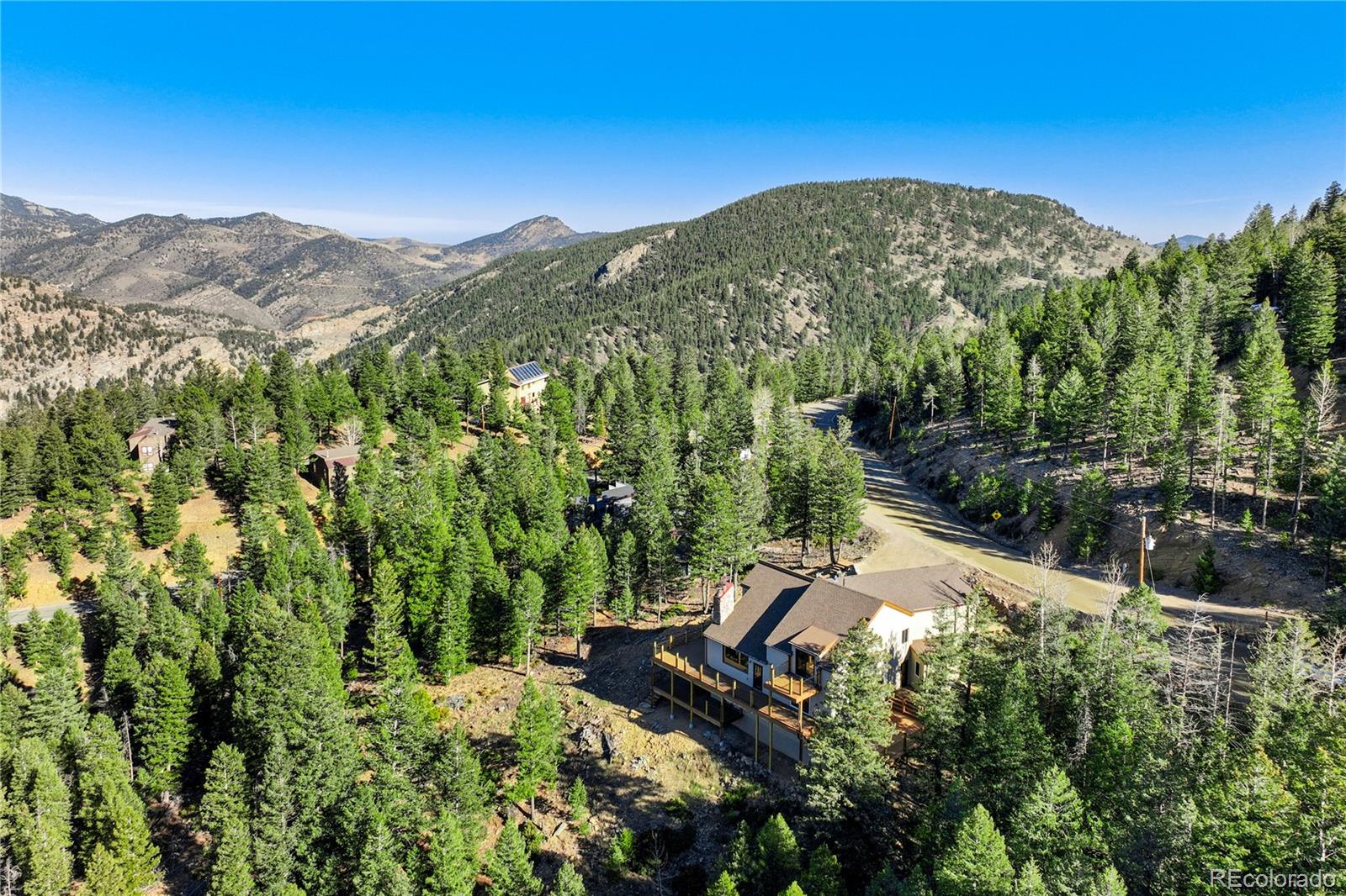 85 Santa Fe Mountain Road Evergreen, CO 80439 - Photo 41 of 47 a view of a house with a yard