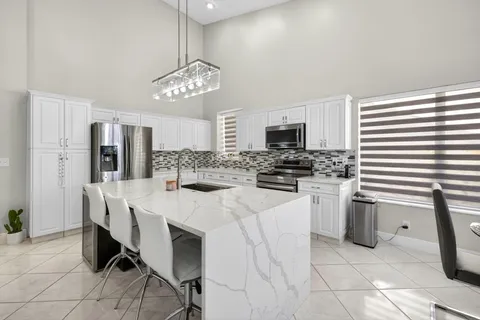 a kitchen with refrigerator and cabinets