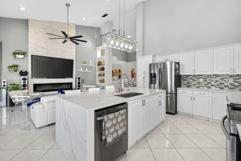 a kitchen with a stove a sink and a refrigerator