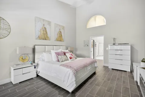 a bedroom with a bed and a chandelier