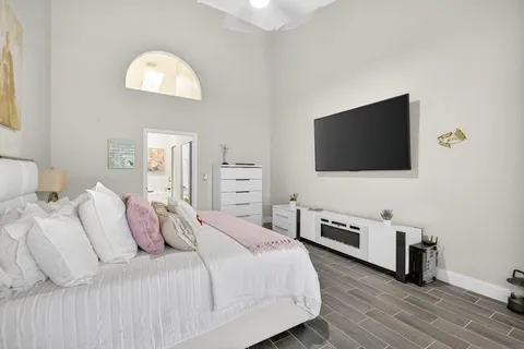 a bedroom with a bed and a flat screen tv