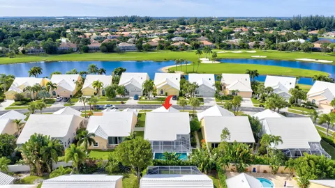 an aerial view of a house with a yard and lake view