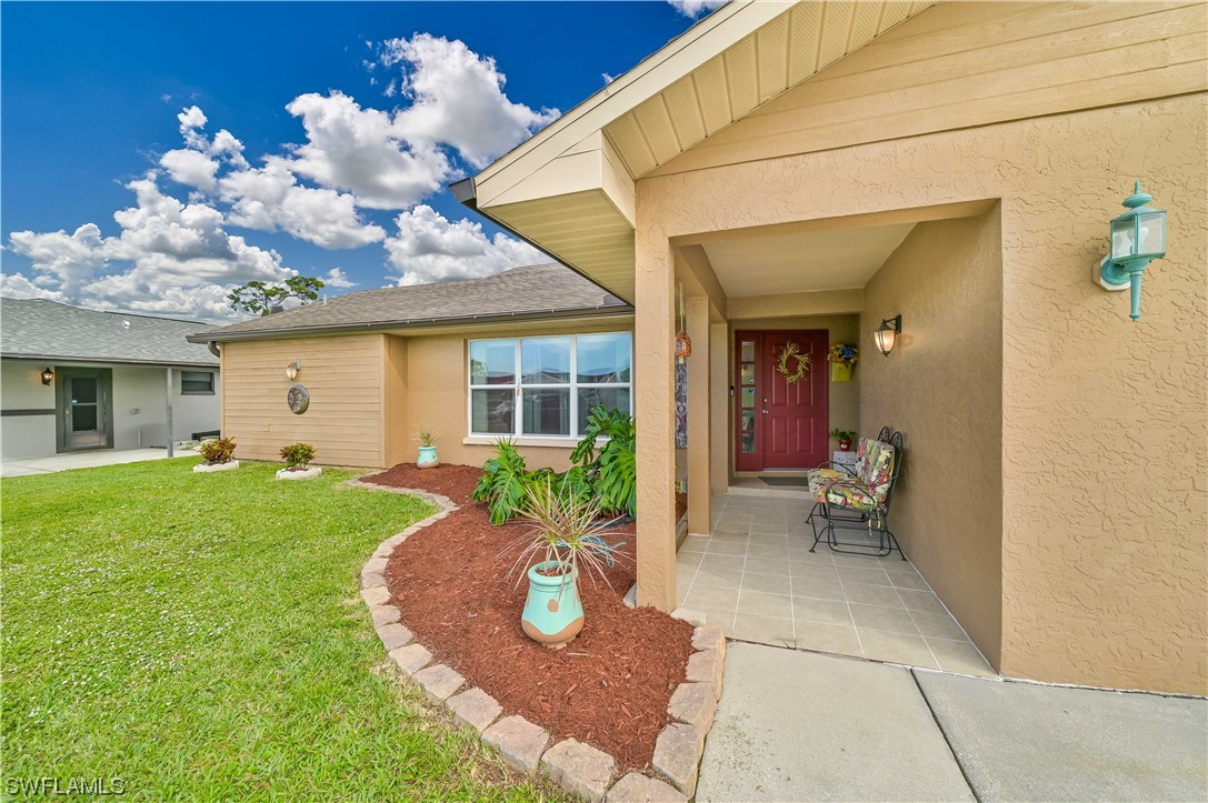 17433 Duquesne Road Fort Myers, FL 33967 - Photo 3 of 28 a view of a house with backyard porch and garden