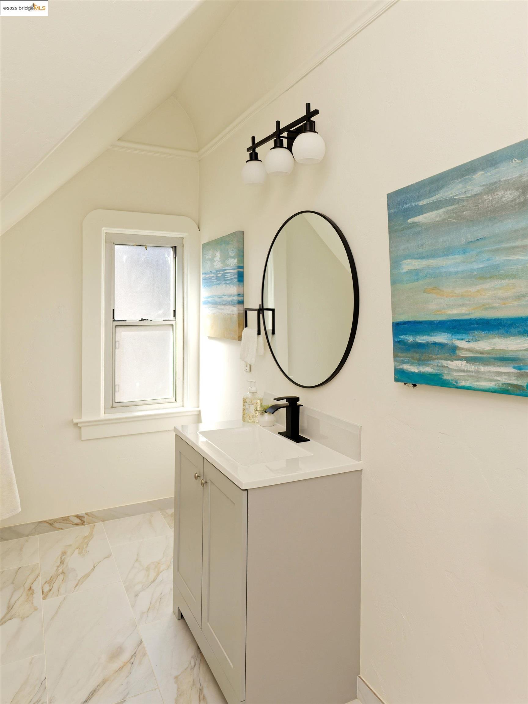 1033 Magnolia Street Oakland, CA 94607 - Photo 15 of 23 a bathroom with a sink mirror vanity and a window
