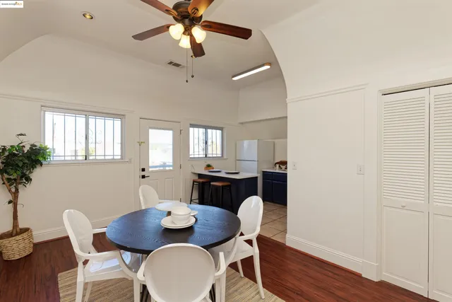 a dining room with furniture a chandelier and wooden floor