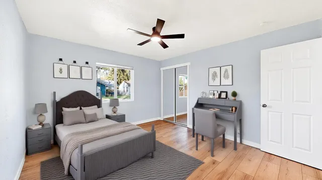 a bedroom with a bed and wooden floor