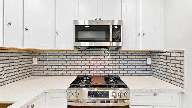 a bathroom with a washing machine and a sink