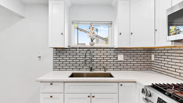 a view of a sink and a microwave