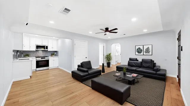 a living room with furniture kitchen and a fireplace