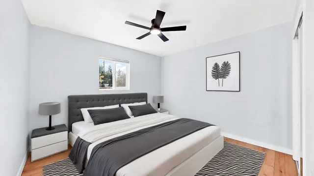 a bedroom with a large bed and a window