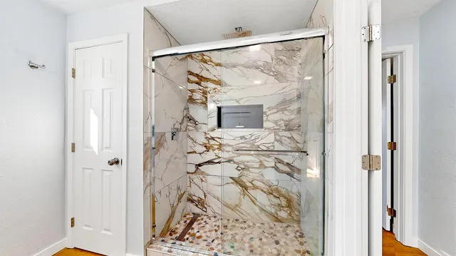 a bathroom with a shower and a view of bathroom