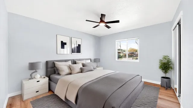 a bedroom with a bed and a potted plant