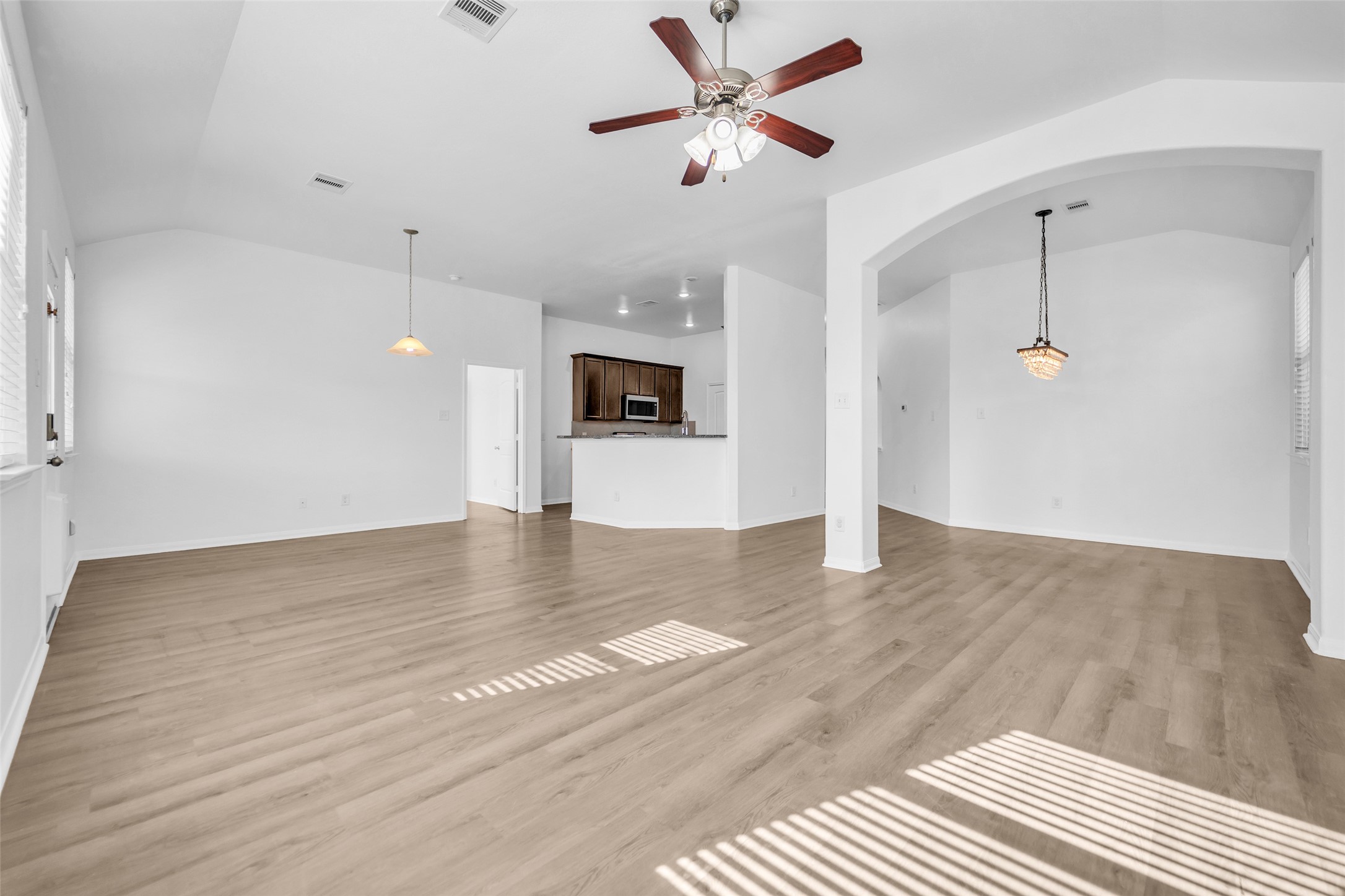 4707 Waukegan Road Conroe, TX 77306 - Photo 4 of 31 Unfurnished view of the living room, dining area, and kitchen.