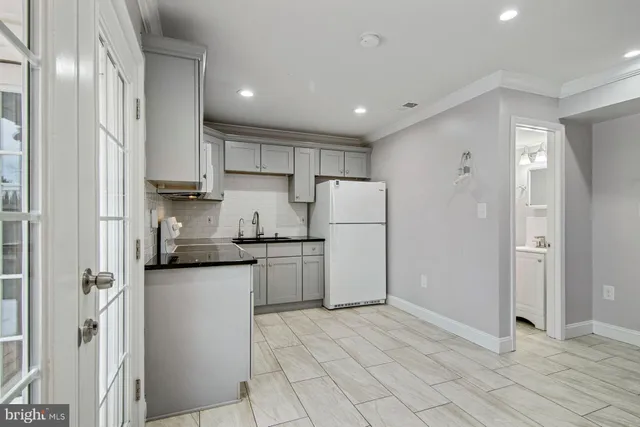 a kitchen with refrigerator and cabinets