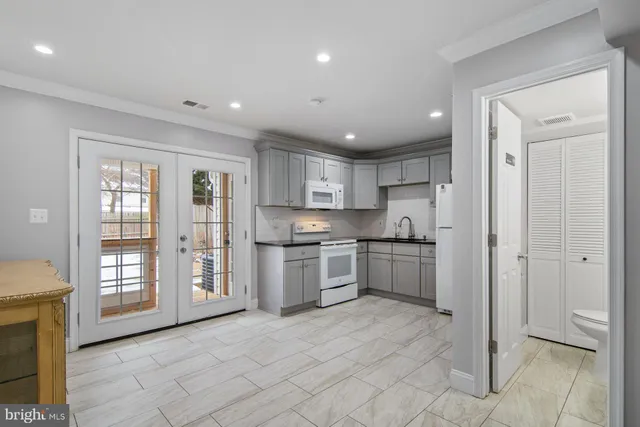 a kitchen with stainless steel appliances granite countertop a refrigerator and a sink