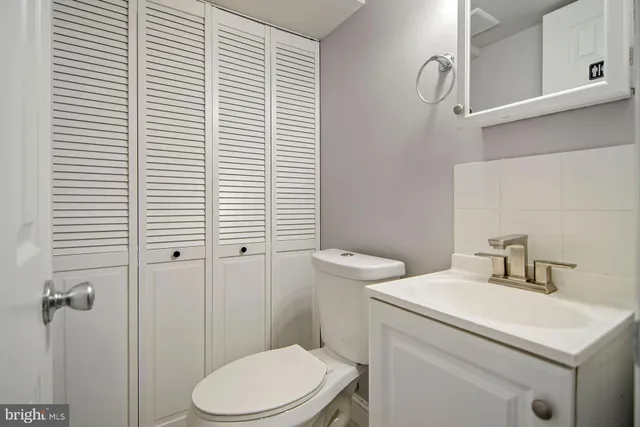 a white toilet sitting next to a bathroom sink