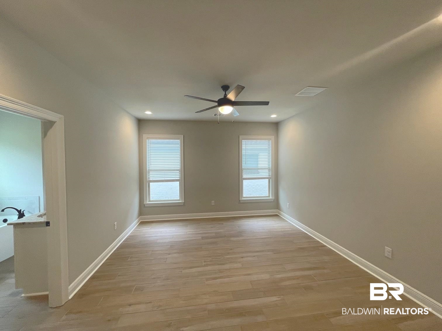 1412 Fenton Circle Foley, AL 36535 - Photo 5 of 15 Unfurnished room featuring ceiling fan and wood-type flooring