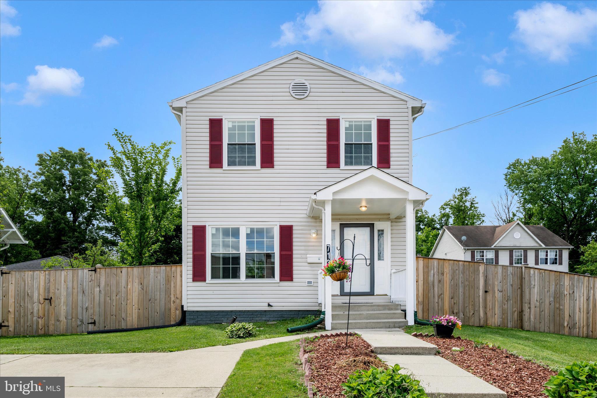 713 Seek Lane Silver Spring, MD 20912 - Photo 55 of 60 a front view of a house with garden