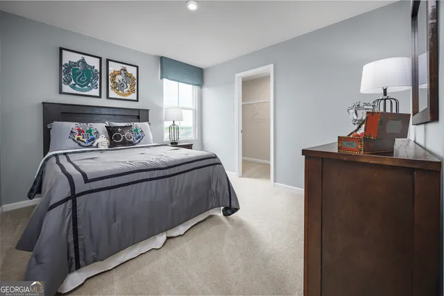 a bedroom with a bed and a lamp on table