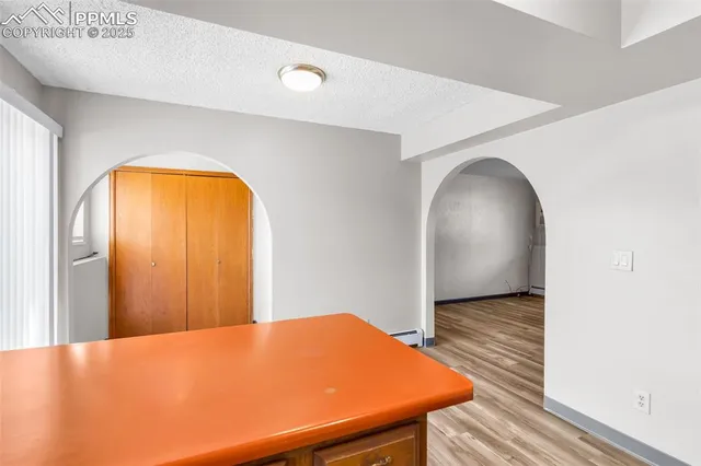 a view of a room with wooden floor and pool table