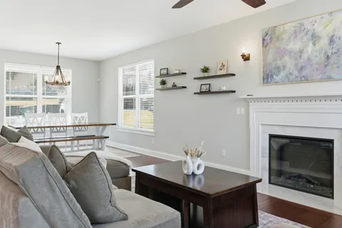 a kitchen with granite countertop a sink stove and wooden floor