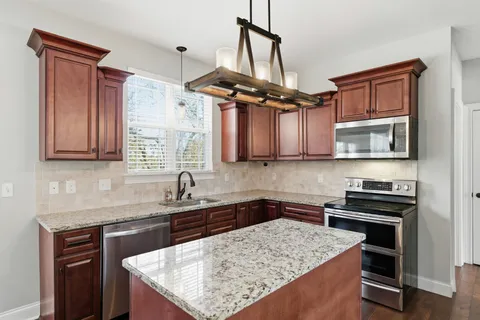 a kitchen with refrigerator and cabinets
