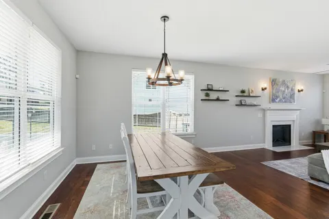 an entryway with wooden floor and cabinet