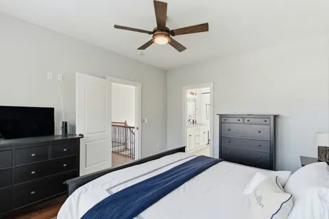 a bathroom with a granite countertop sink a toilet and shower