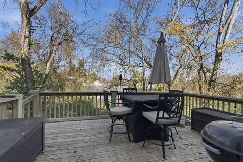 a front view of a house with yard and green space