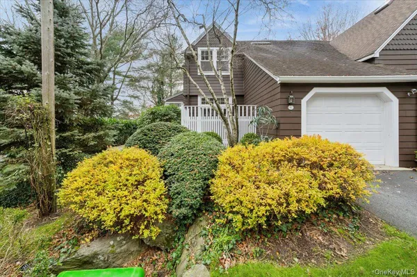 a view of a house with large trees