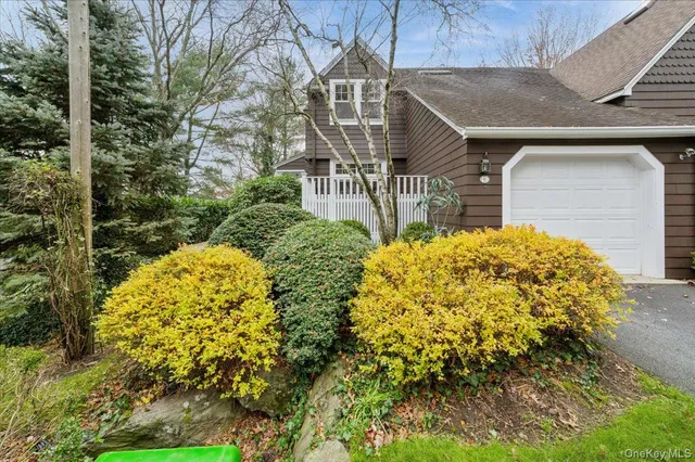 a view of a house with large trees