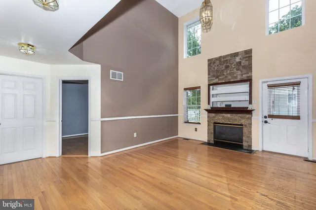 a view of a livingroom with a fireplace cabinet and a window