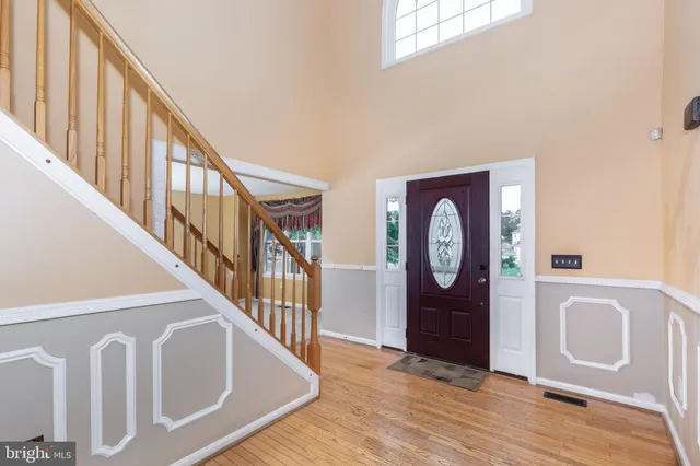 a view of an entryway with wooden floor and door