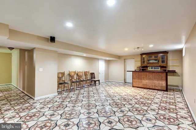 a view of a kitchen with a sink and a refrigerator