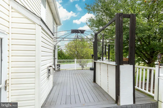 a view of a balcony with wooden floor and fence