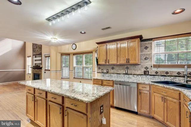 a kitchen with granite countertop a sink and cabinets