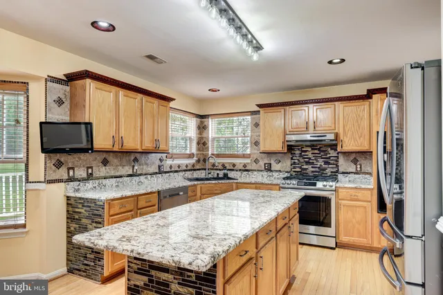 a kitchen with a stove a sink and a refrigerator