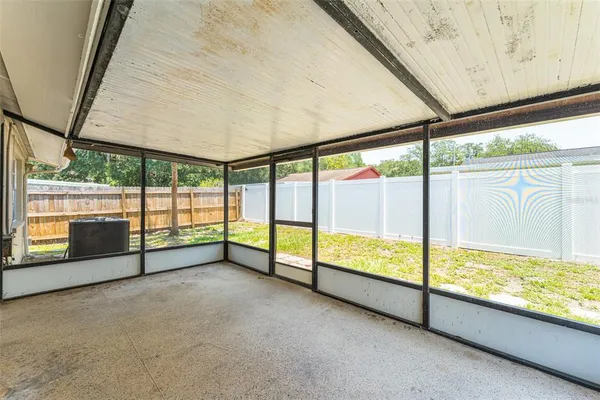 a view of an empty room with a large window with outer view