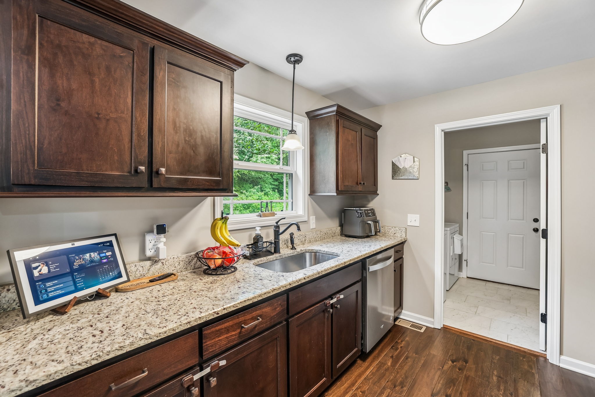 1546 South Spring Street Manchester, TN 37355 - Photo 21 of 53 a kitchen with stainless steel appliances granite countertop wooden cabinets a sink and dishwasher with wooden floor