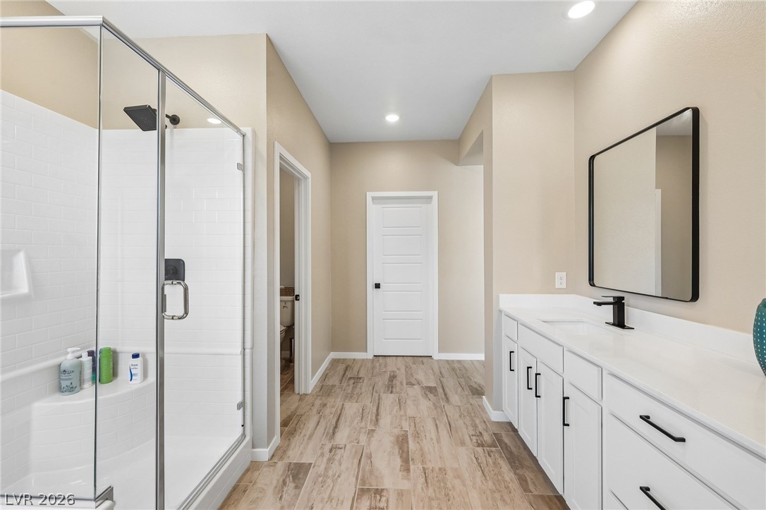 194 Viento Ridge Street Henderson, NV 89012 - Photo 36 of 72 Gleaming tile floors and a glass-enclosed shower highlight this modern primary bath.