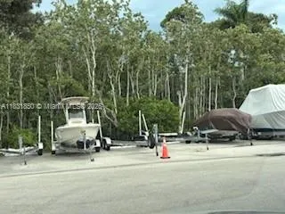 a balcony with table and chairs and potted plants