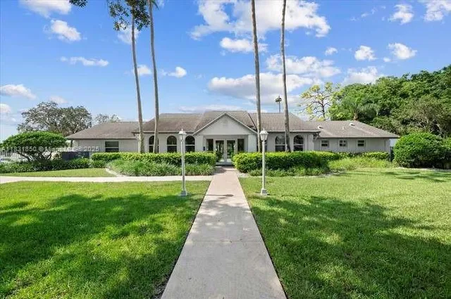 a dining room with furniture a rug and a painting