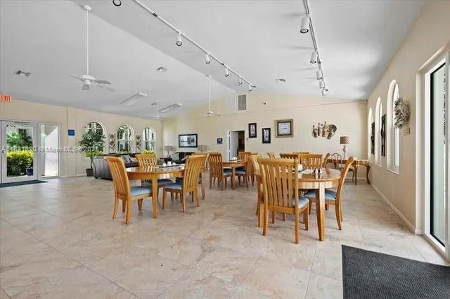a living room with furniture a table and a large window