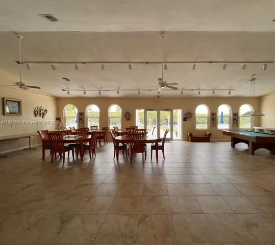 a view of a patio with a table and chairs under an umbrella