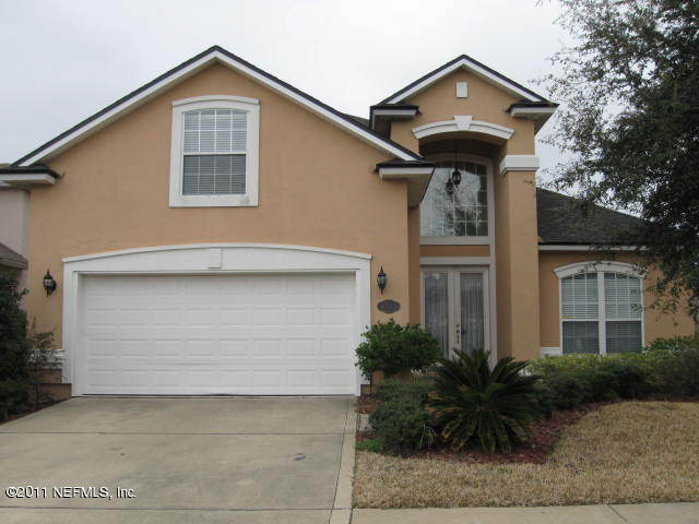4583 Reed Bark Lane Jacksonville, FL 32246 - Photo 1 of 5 a front view of a house with garden